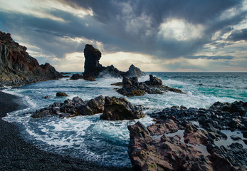 Dramatic shot of stormy coastline with black rocks and high waves on Snaefellsnes peninsula Iceland - obrazy, fototapety, plakaty