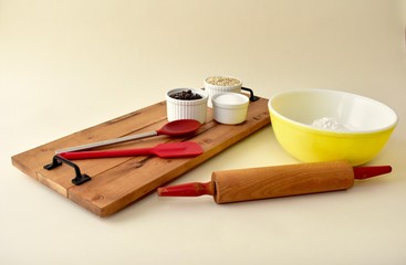 Home baking ingredients with mixing bowls and kitchen utensils 