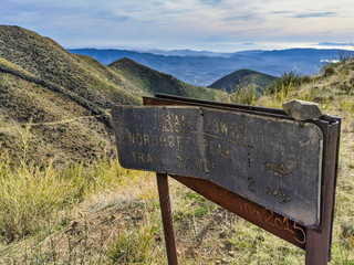 Trail sign damaged in wildfires in the mountains of Ojai, California