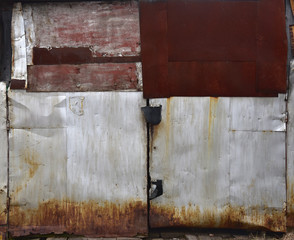 Gray metal double door, old garage door, paint peeling off