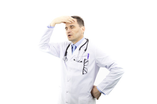 Portrait of adult physician man with glasses in chest pocket wearing medical gown and stethoscope over isolated white background tired hold hands on head feeling fatigue and headache. Close eyes.