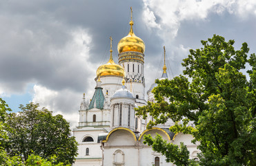 Fototapeta na wymiar Golden domes of Ivan the Great bell tower and Archangel Cathedral