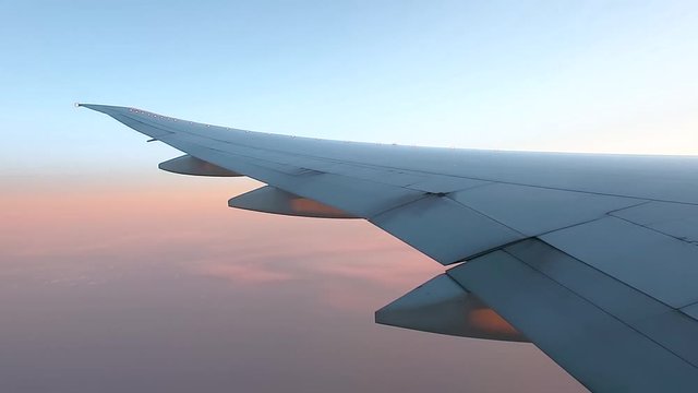 A lot of shots of a small airplane wing flying high above clouds during the sunset, sky from the window view. air plane aircraft flight concept.