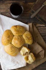 Salty filled buns. Wooden background. White and brown towel. 