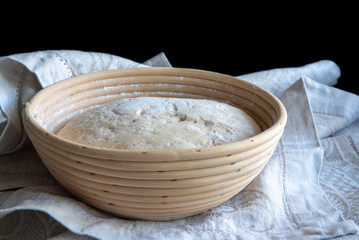 Bread dough rising in basket, home made