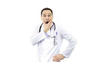 Fototapeta premium Portrait of adult physician in white medical coat with stethoscope over neck, medical professional scared in shock, expressing panic and fear isolated over white background.