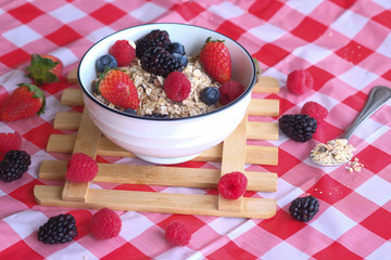 Healthy breakfast, oatmeal with fresh berries in a bowl.
