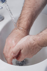 Fototapeta premium detail of man washing his hands. health and personal hygiene. virus prevention. covid-19