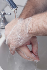 detail of man washing his hands. health and personal hygiene. virus prevention. covid-19