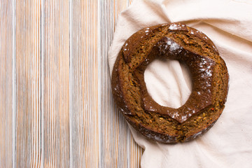 Rustic a round wholegrain rye-wheat farm bread with a hole in the middle with sunflower seeds.