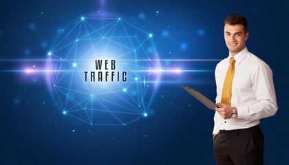 Businessman thinking about security solutions with WEB TRAFFIC inscription