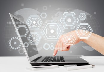 Male hands using a laptop on office table