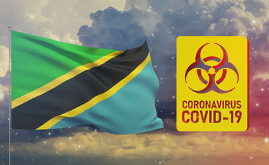 COVID-19 Visual concept - Coronavirus COVID-19 biohazard sign with flag of Tanzania. Pandemic 3D illustration.