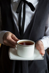 The woman drink hot tea or coffee.