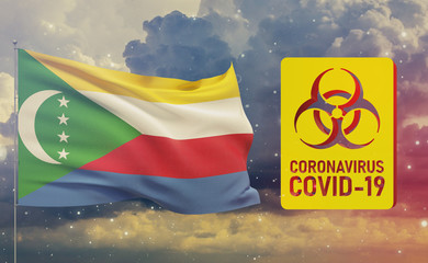COVID-19 Visual concept - Coronavirus COVID-19 biohazard sign with flag of Comoros. Pandemic 3D illustration.