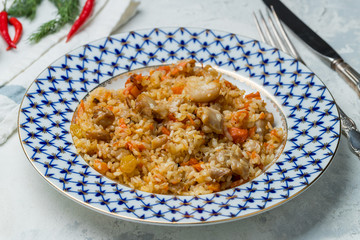 pilaf with chicken on grey concrete