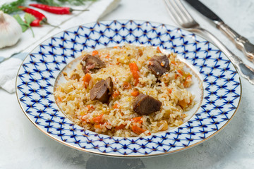 pilaf with beef on grey concrete