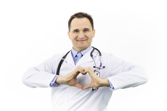 Portrait of Caucasian adult doctor in white coat with stethoscope over neck on a white background. Depicts a heart with hands. Friendliness and hospitality. Caring for people. A wide smile, a laugh