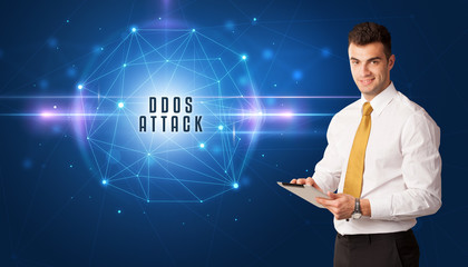Fototapeta na wymiar Businessman thinking about security solutions with DDOS ATTACK inscription