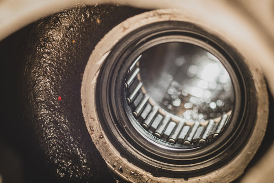 Silicone or NBR seal installed in a hollow shaft in front of a needle roller bearing. Macro photo of an industrial installation ready to receive rotating shaft