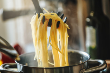 Cooked boiling spaghetti pasta in pot