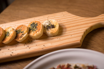 bread board whit spices, chimichurri and olive oil