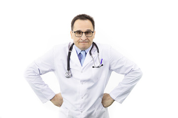 Fototapeta premium Middle-aged handsome doctor in white coat, glasses and stethoscope looking at camera with anger face with hands on sides, isolated white background. healthcare, negative emotions and medicine concept