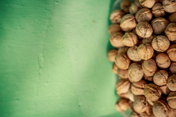 walnuts on a green background with space for text