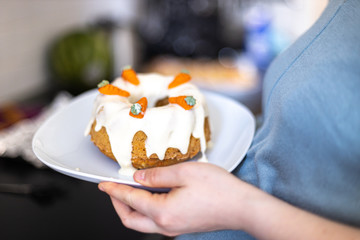 pregnant woman is holding carrot cake