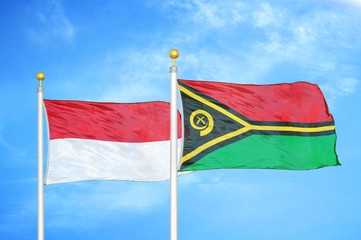 Indonesia and Vanuatu two flags on flagpoles and blue cloudy sky