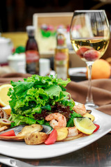 salad with seafood, with mussels and shrimps on a wooden background