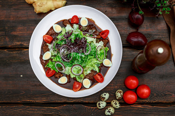 Warm salad with meat in ginger sauce