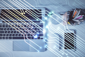 Multi exposure of data drawing hologram over topview of study desk background with computer. Concept of technology.