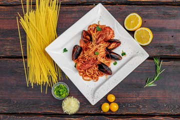 pasta with seafood, with mussels and shrimps on a wooden background