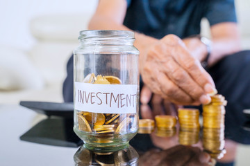 Jar full of golden coins with investment text