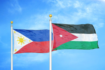 Philippines and Jordan two flags on flagpoles and blue cloudy sky
