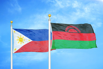 Philippines and Malawi two flags on flagpoles and blue cloudy sky