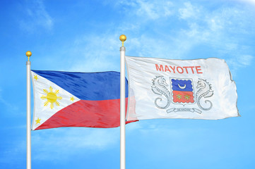 Philippines and Mayotte two flags on flagpoles and blue cloudy sky