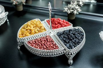 dried fruits and oriental sweets on a silver plate