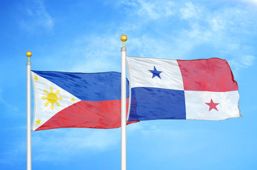 Philippines and Panama two flags on flagpoles and blue cloudy sky