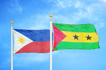 Philippines and Sao Tome and Principe two flags on flagpoles and blue cloudy sky