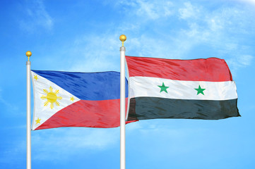 Philippines and Syria two flags on flagpoles and blue cloudy sky