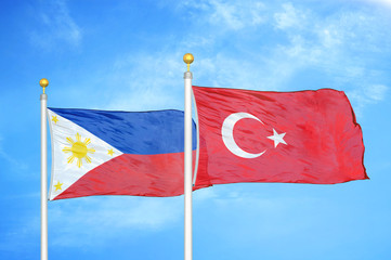Philippines and Turkey two flags on flagpoles and blue cloudy sky