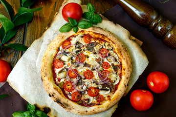 pizza with mozzarella cheese with tomatoes red onion and tenderloin