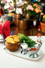 Pastry with greens and sacks on a wooden surface