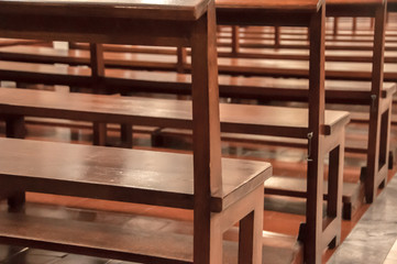 Detail of wooden benches inside a church