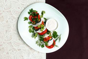 fried eggplant with tomatoes and greens under sauce with wine
