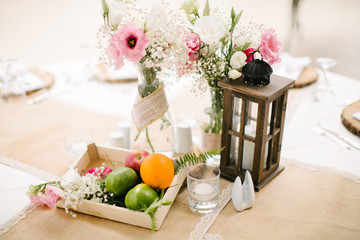 Wedding dining table and colorful flowers. Wedding day and wedding dining table. Fruit basket, apple, orange, lime.