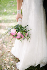 Pink bridal flower. The bride is holding it.