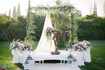 Wedding arch. Rustic wedding. Wedding area covered with flowers.